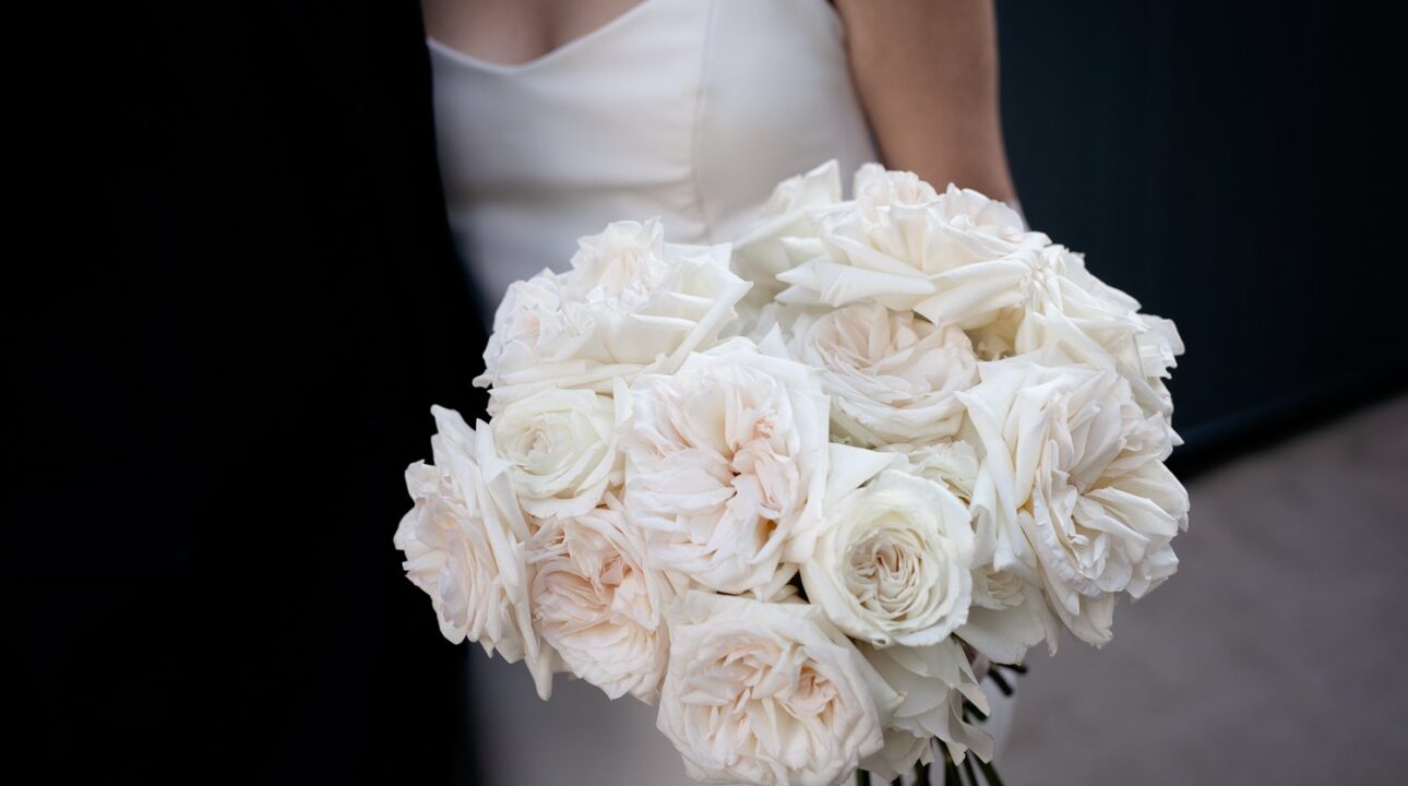 Elegant Bride with White Rose Bouquet in Modern Architectural Setting. This bride adorned her bouquet with an exquisite collection of garden roses.