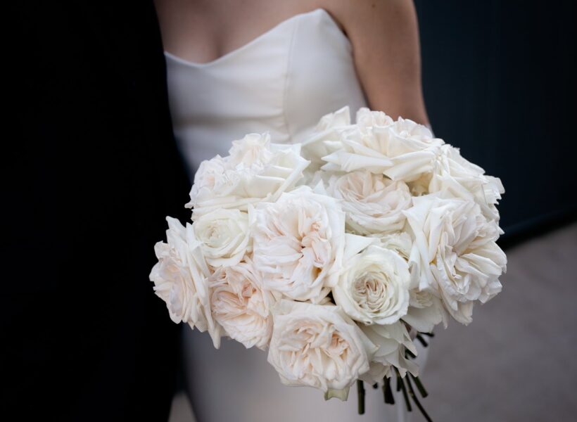 Elegant Bride with White Rose Bouquet in Modern Architectural Setting. This bride adorned her bouquet with an exquisite collection of garden roses.