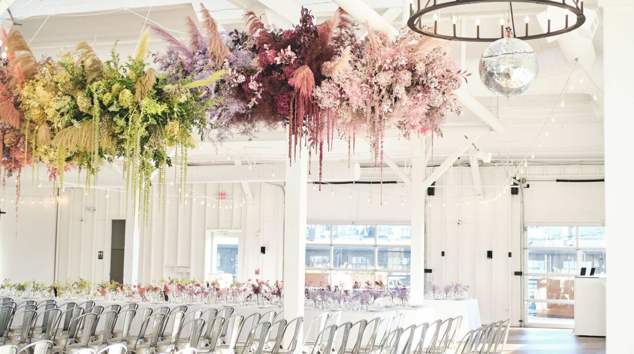 Rainbow-themed wedding ceremony with colorful decorations at 14 TENN Venue in Nashville.