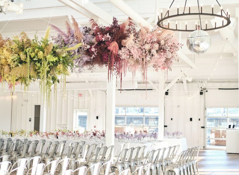 Rainbow-themed wedding ceremony with colorful decorations at 14 TENN Venue in Nashville.