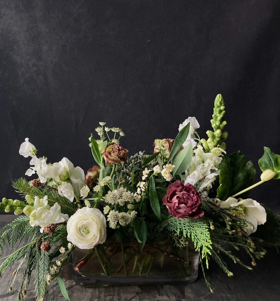 Holiday centerpiece featuring seasonal flowers, perfect for adding warmth and elegance to festive gatherings and holiday decor.