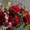 A romantic arrangement featuring red roses.