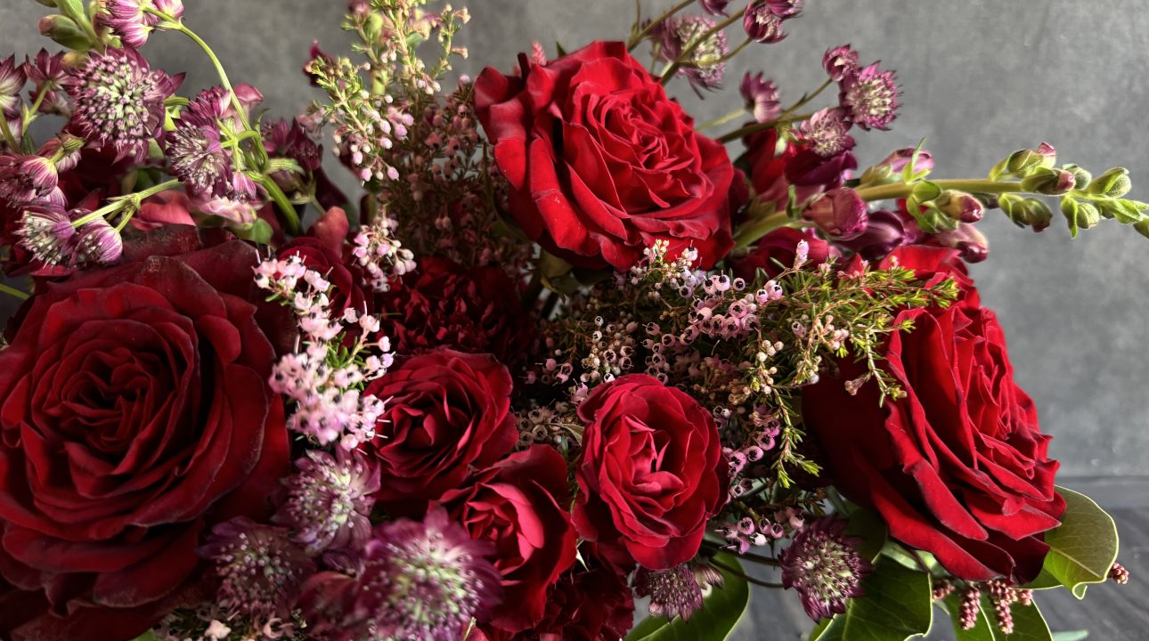 A romantic arrangement featuring red roses.