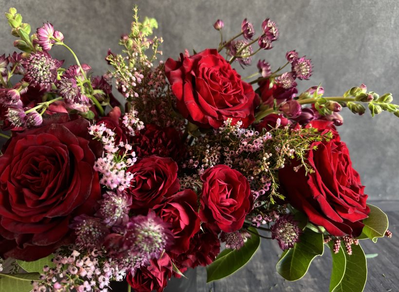 A romantic arrangement featuring red roses.