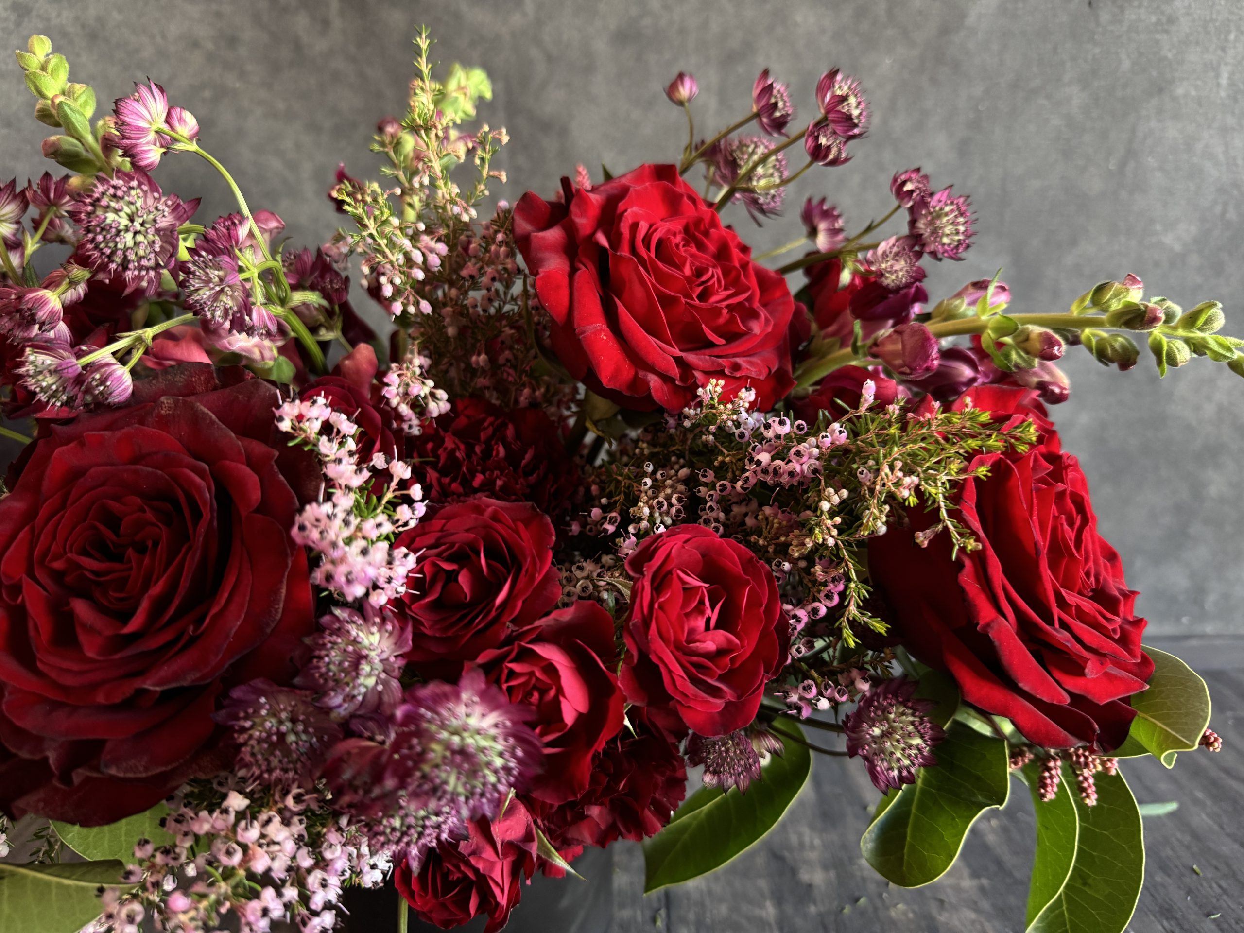 A romantic arrangement featuring red roses.